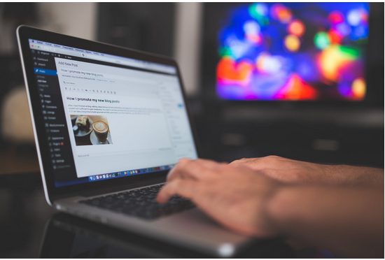Close up of person typing on a laptop 