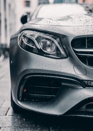 Image of a grey car parked on a pavement 